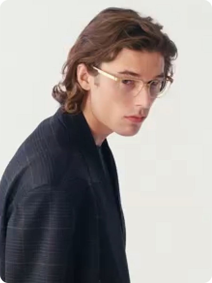 Person wearing glasses and a dark jacket on a light gray background