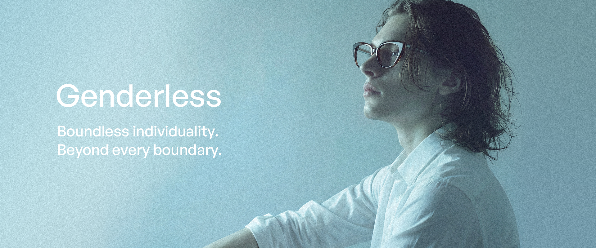 Person wearing sunglasses with 'Genderless' text on a light blue background