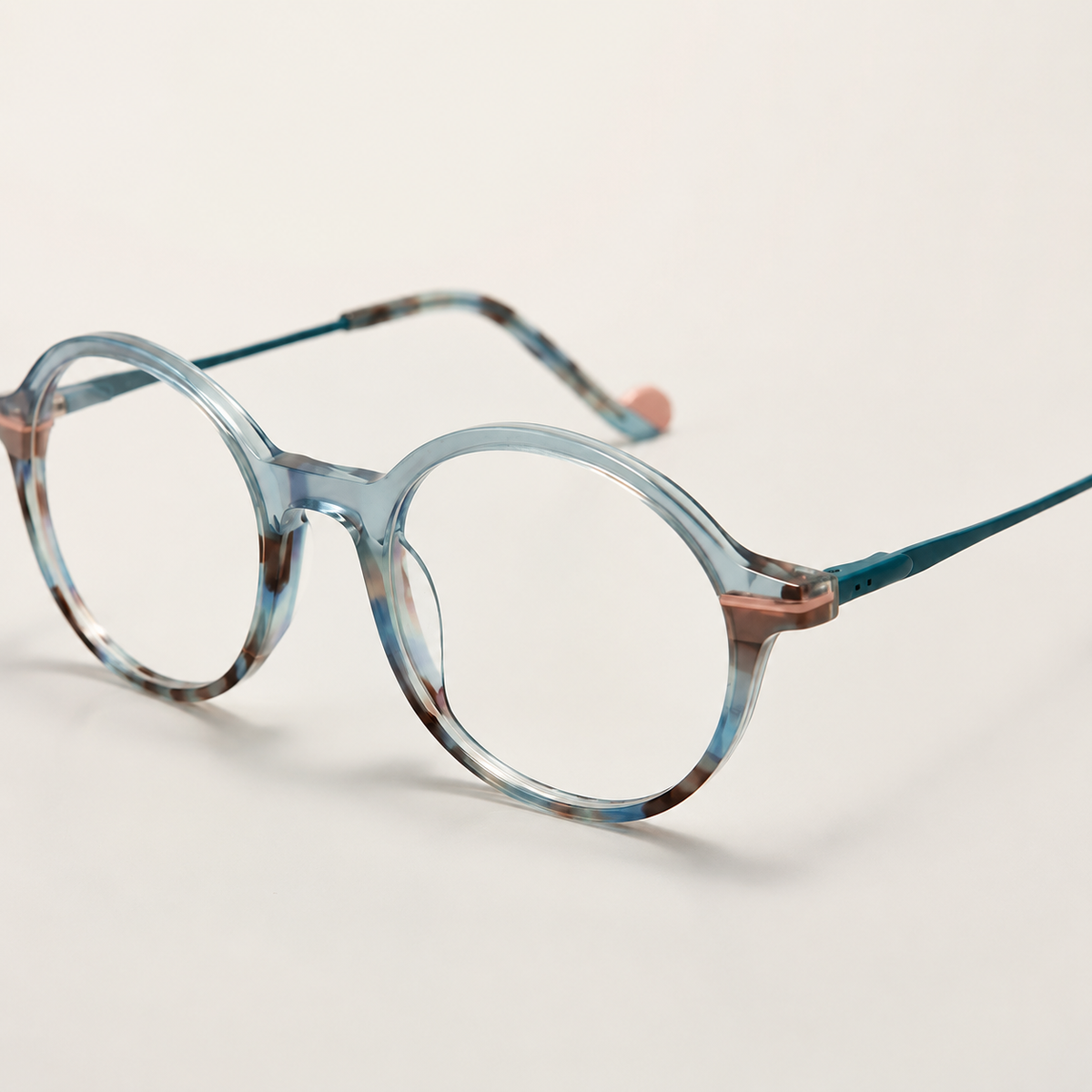 Featuring a classic round silhouette in teal acetate, finished with...