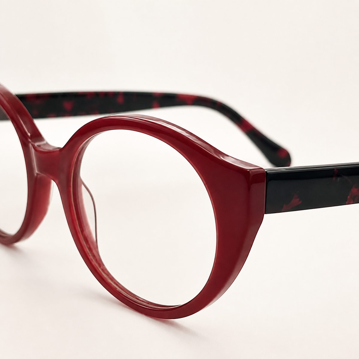 Featuring a classic round silhouette in black red acetate, finished...