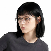 Person wearing glasses and a dark shirt on a white background