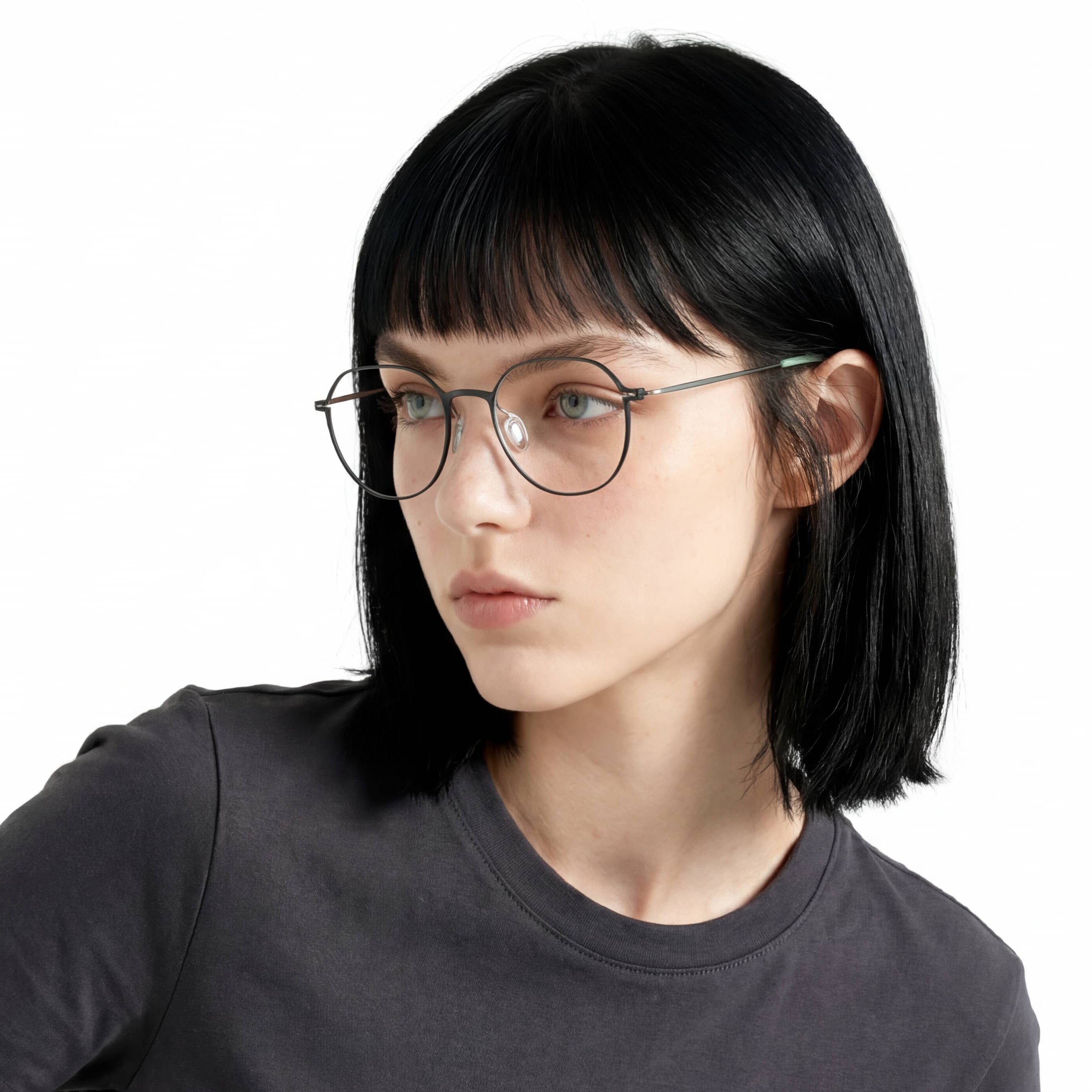 Person wearing glasses and a dark shirt on a white background