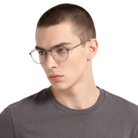 Person wearing glasses and a gray shirt on a white background