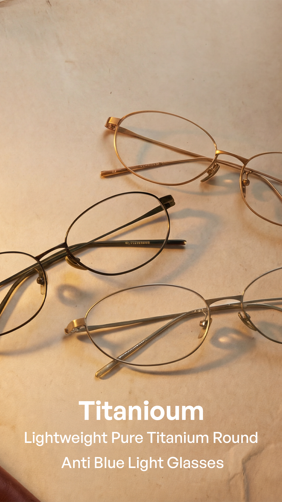 Three pairs of round titanium eyeglasses frames in different metallic finishes (gold, bronze, and dark gunmetal) arranged on a textured beige surface with text overlay at the bottom.