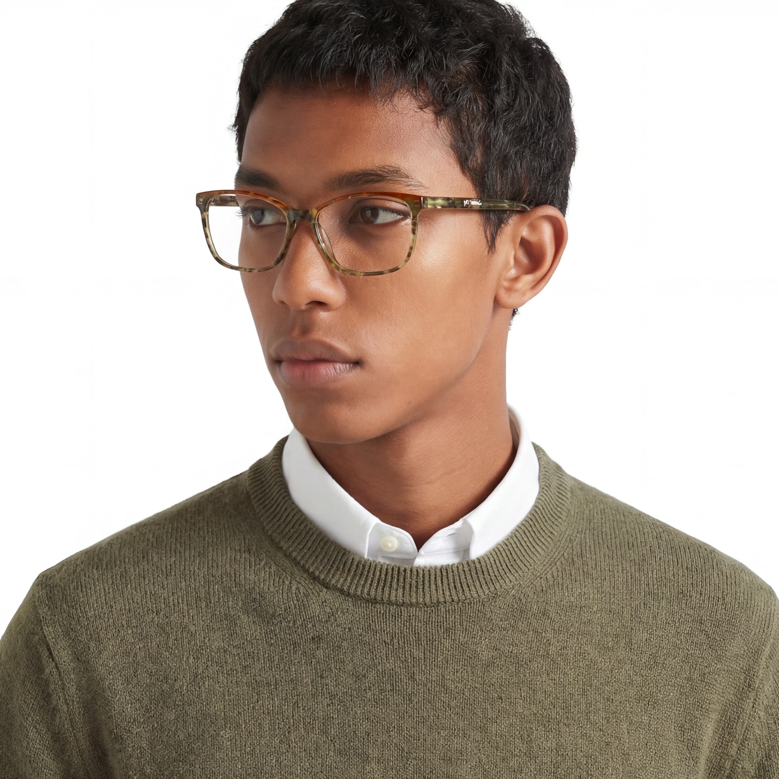 Person wearing glasses and a green sweater with a white shirt underneath on a white background