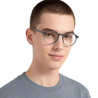 Person wearing gray eyeglasses on a white background