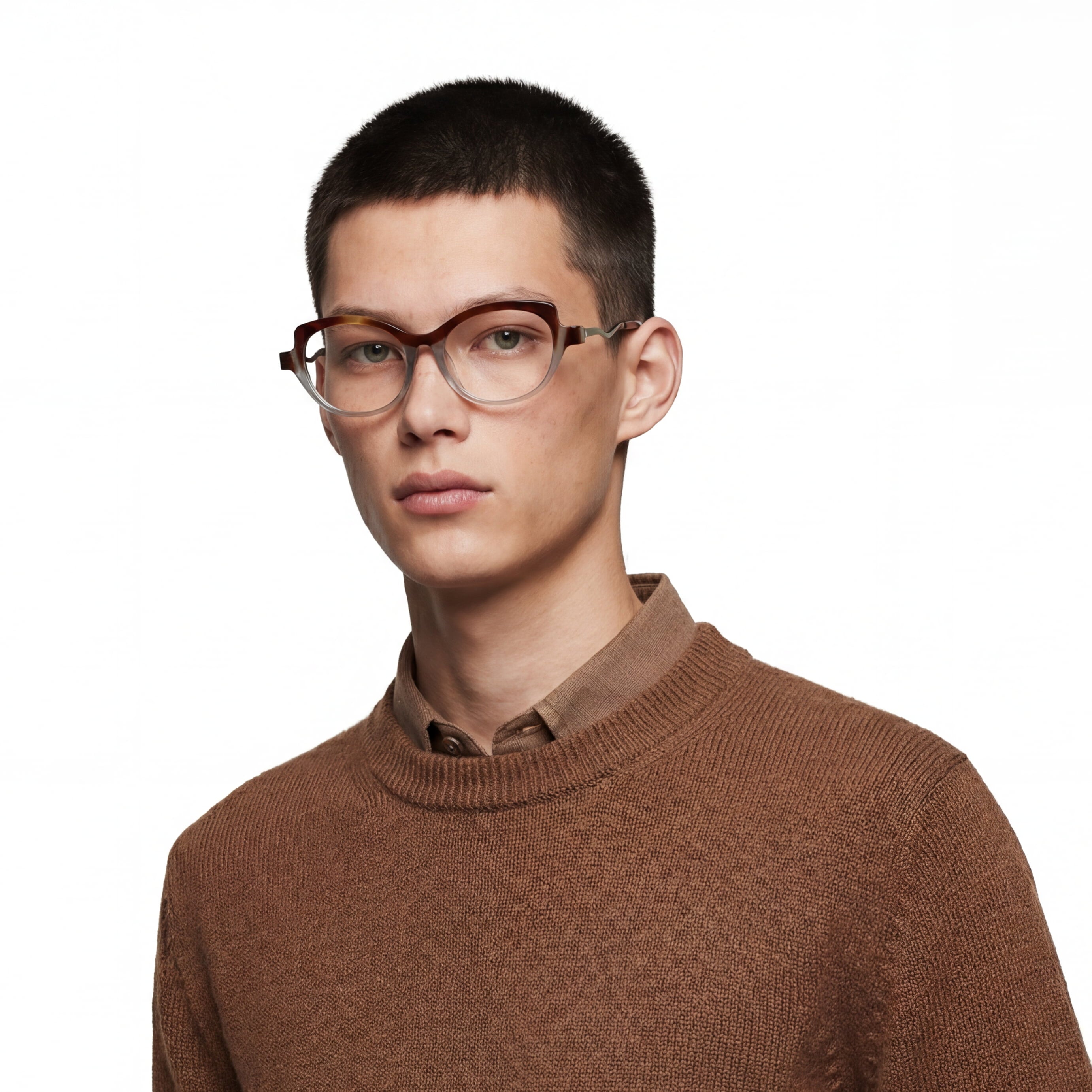 Person wearing glasses and a brown sweater on a white background