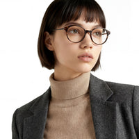 Person wearing glasses with a neutral background
