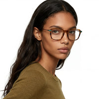 Woman wearing glasses with a neutral background