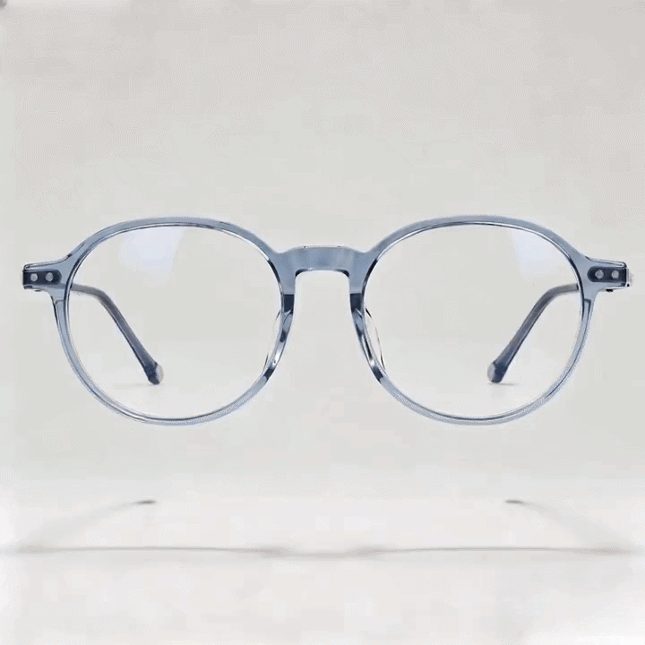 Transparent gray round acetate eyeglasses frame, white studio background
