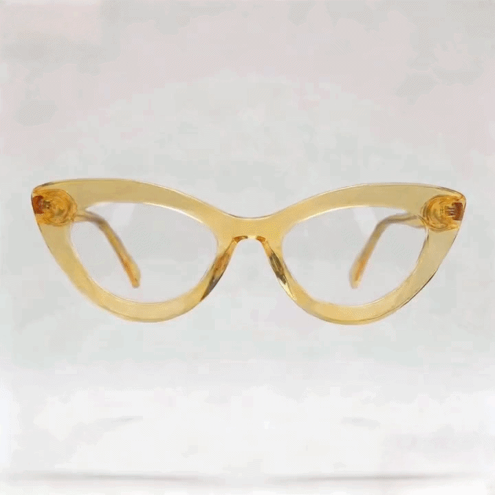 Transparent amber cat-eye acetate eyeglasses frame, white studio background