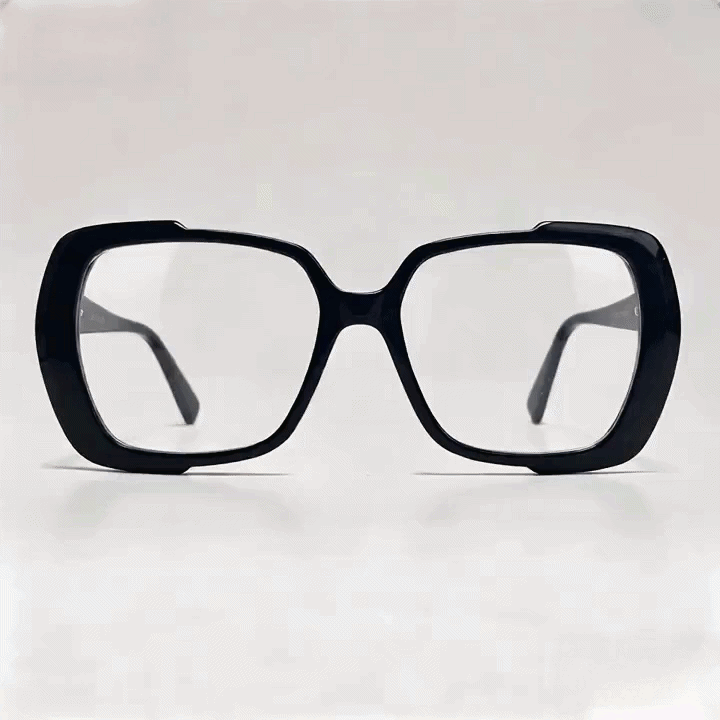 Glossy black oversized square acetate eyeglasses frame, white studio background