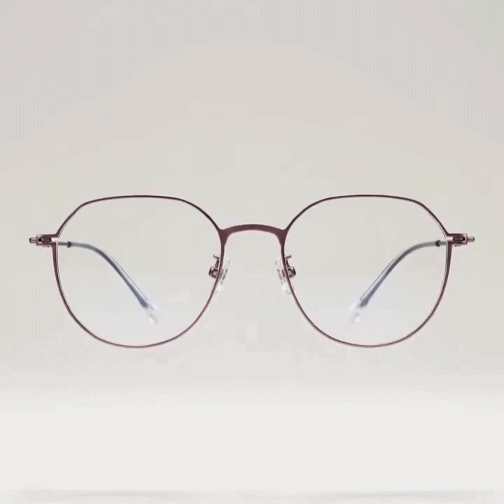 Light rose gold metal octagonal eyeglasses frame with thin slim temple arms, light gray studio background
