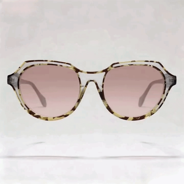 Tortoiseshell oval acetate sunglasses with light pink gradient lenses studio shot