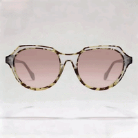 Tortoiseshell oval acetate sunglasses with light pink gradient lenses studio shot