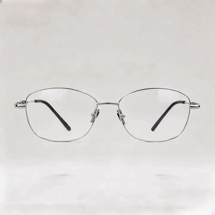 Silver metal round eyeglasses frame with burgundy temple accents, white studio background