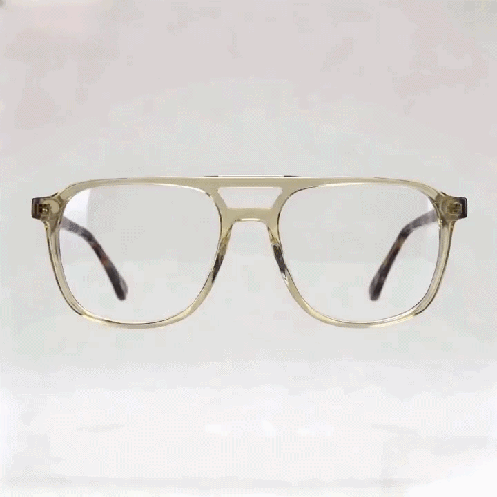 Transparent pale yellow aviator eyeglasses frame with tortoise temples, white studio background