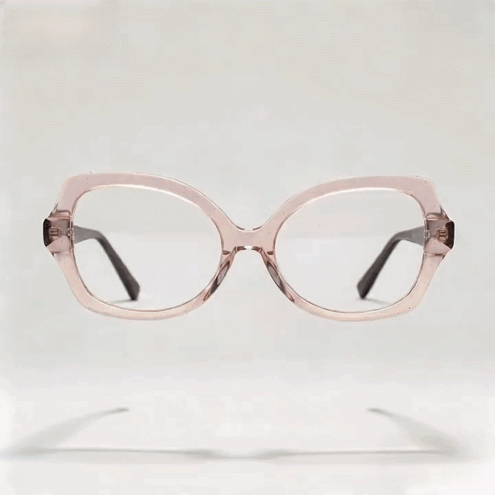 Transparent light pink cat-eye acetate eyeglasses frame, white studio background