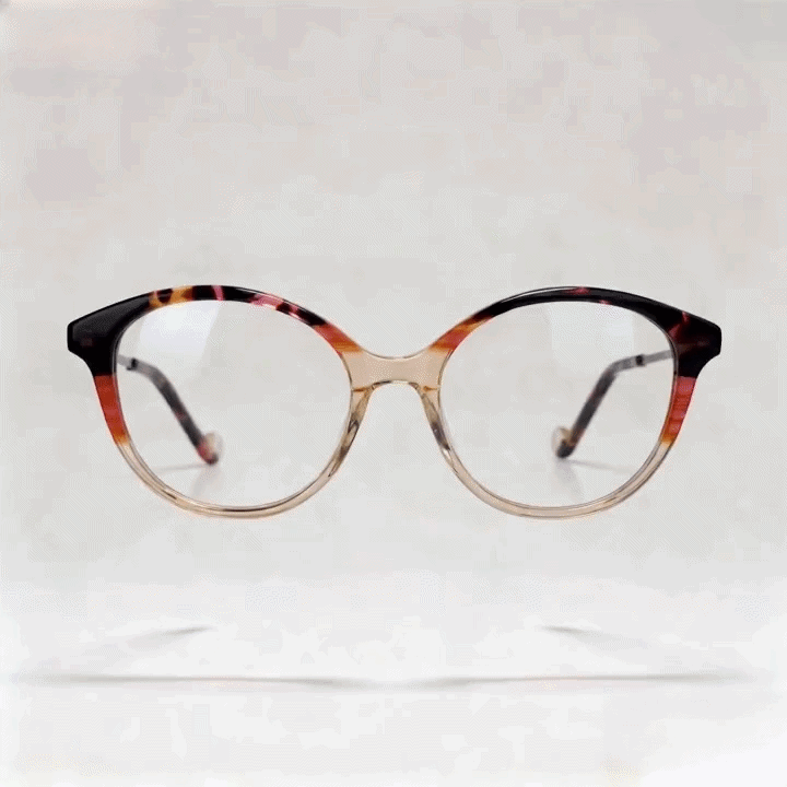 Two-tone gradient amber tortoise cat-eye acetate eyeglasses frame, light gray studio background