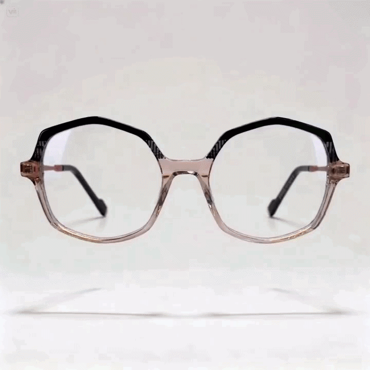 Two-tone transparent peach and black octagonal acetate eyeglasses frame, light gray studio background