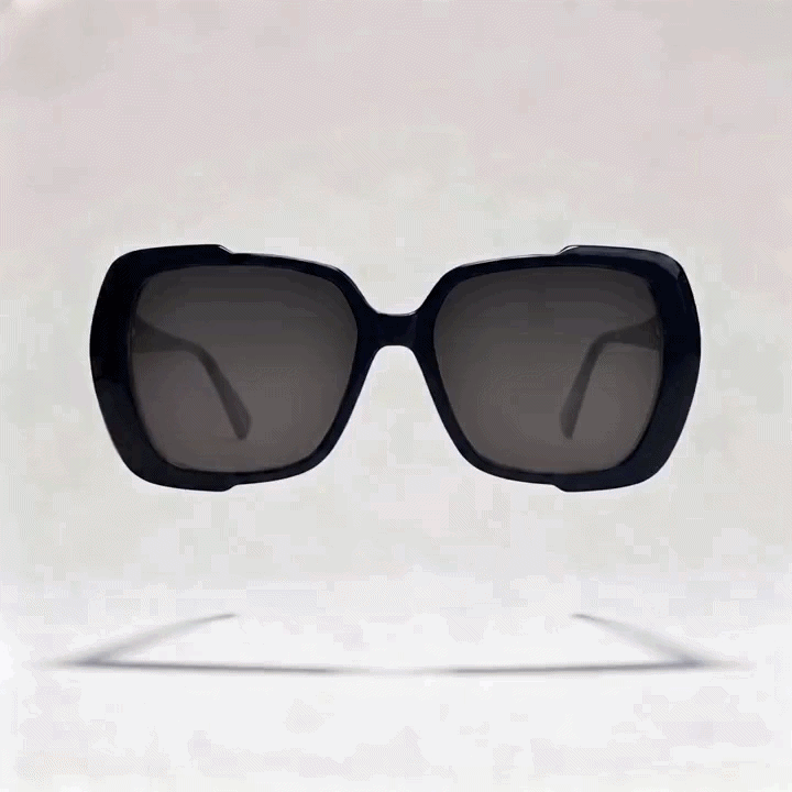 Black oversized square cat-eye acetate sunglasses frame with dark gray tint lenses, light gray studio background