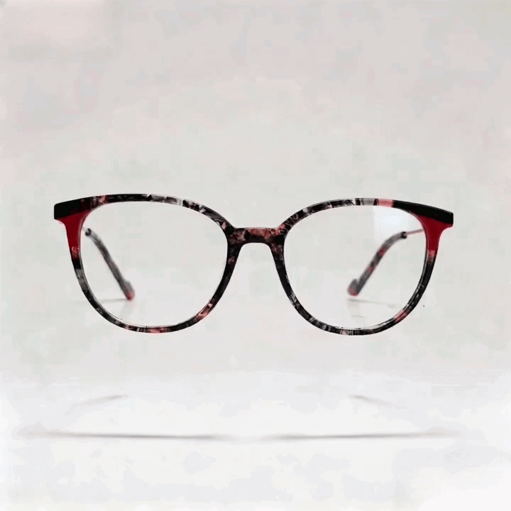 Red marbled two-tone square acetate eyeglasses frame, side profile shot on light gray studio background