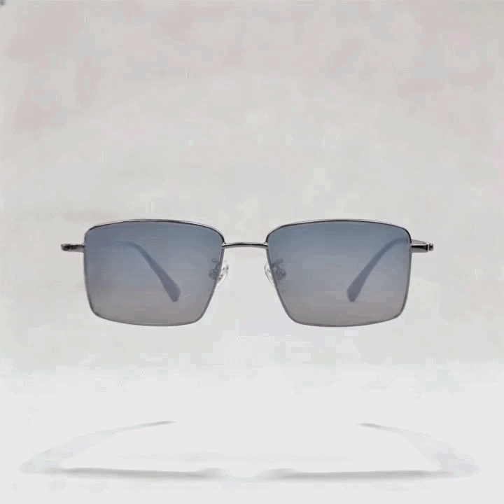 Dark gunmetal metal rectangular sunglasses frame with gradient gray tint lenses, light gray studio background