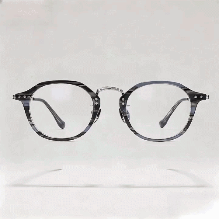 Dark gray tortoise round acetate eyeglasses frame with metal bridge, white studio background