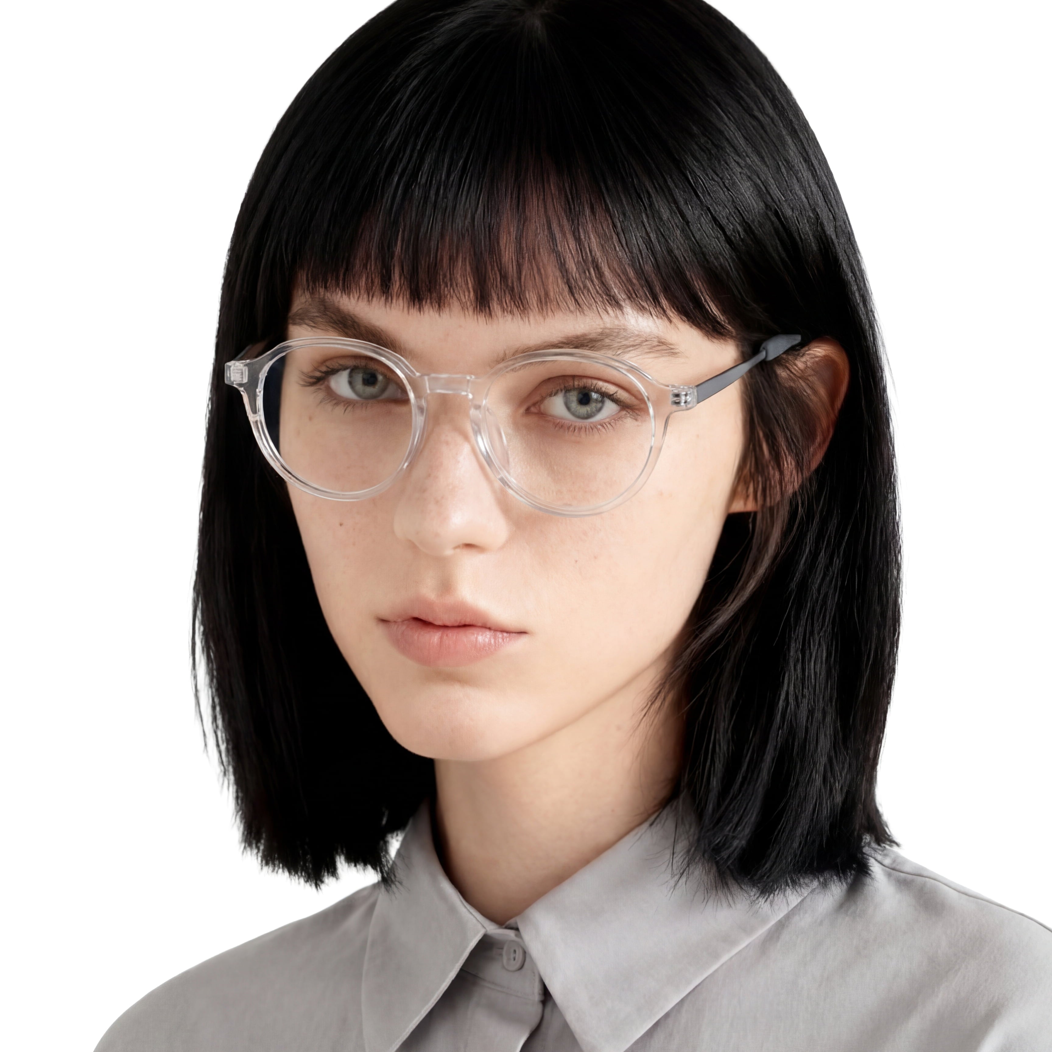 Person wearing clear glasses with a neutral background