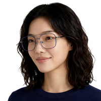Woman wearing glasses with a plain background