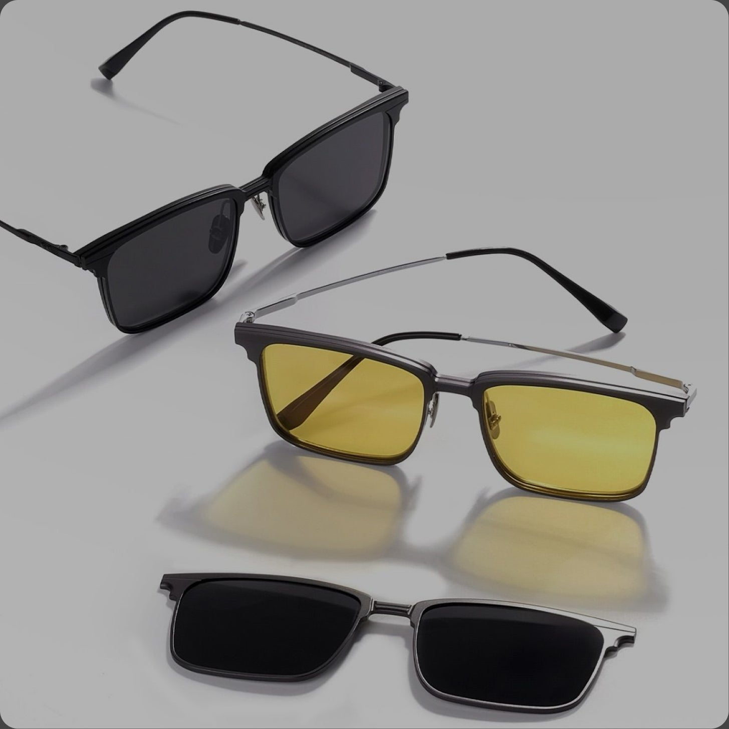 Three pairs of sunglasses with different lens colors on a light gray background