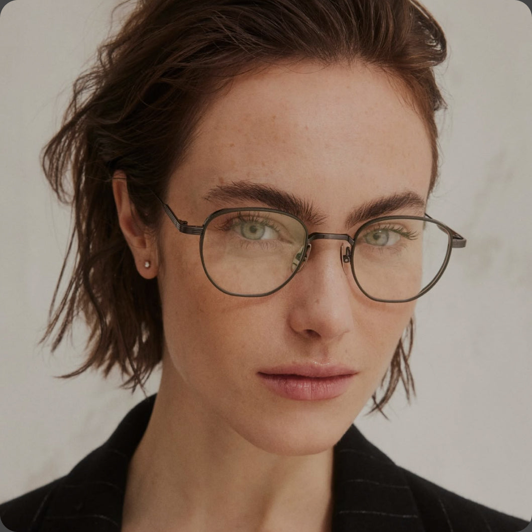 Person wearing glasses with a neutral background