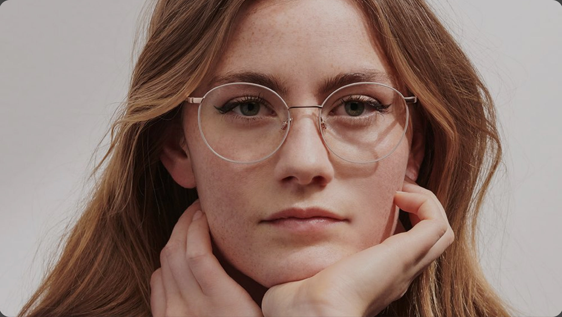 Woman wearing glasses with a neutral background