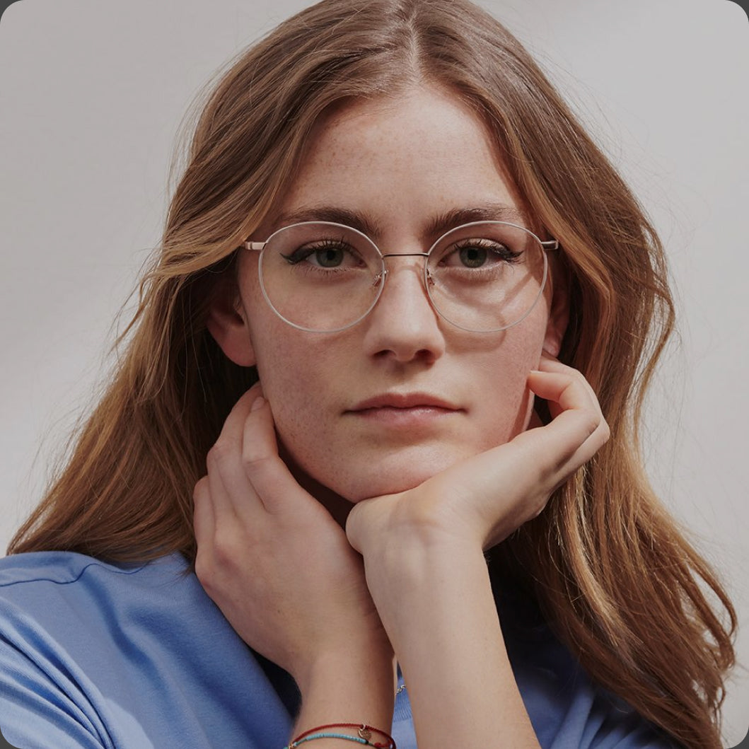 Woman wearing glasses with a neutral background