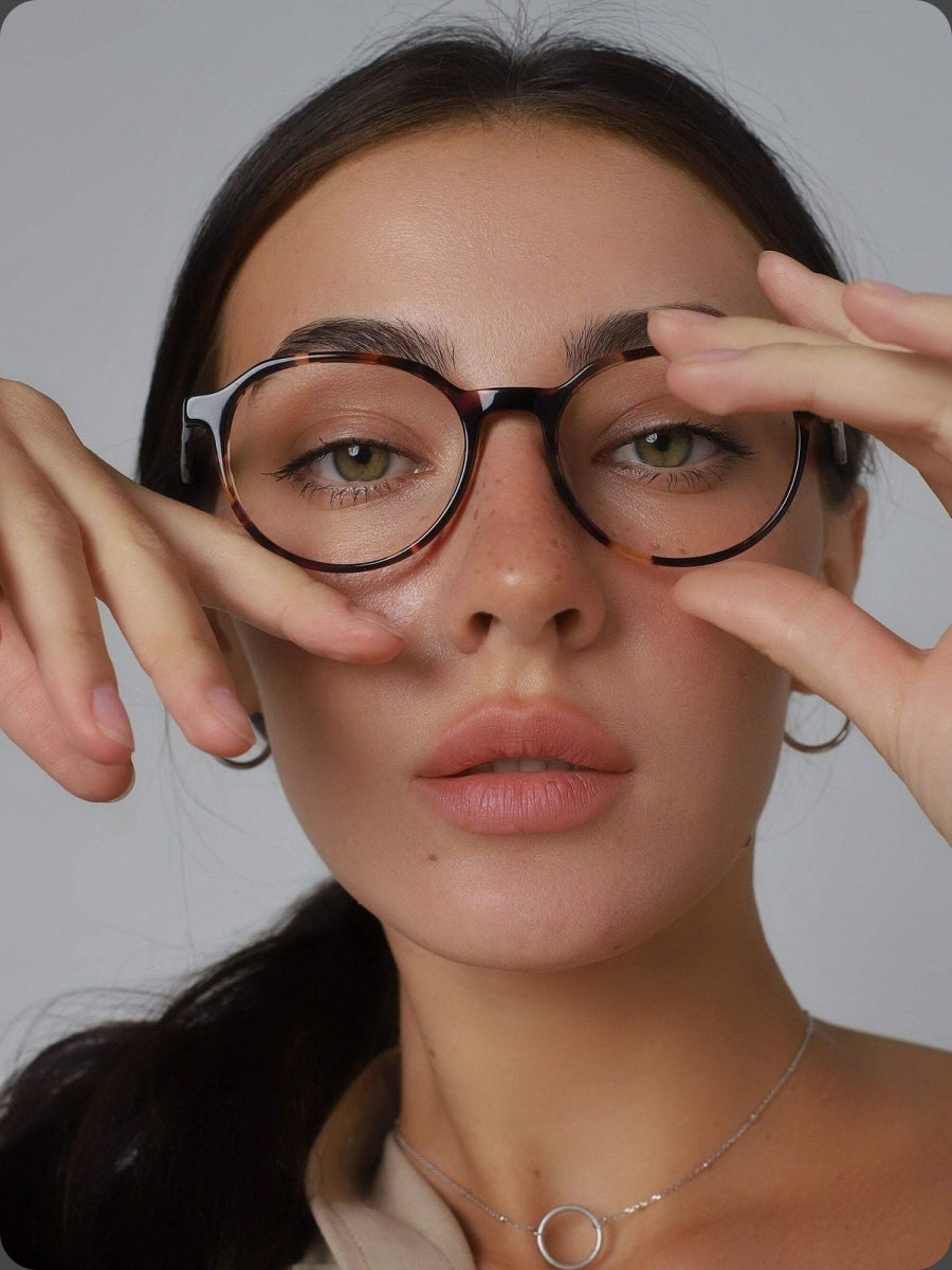 Woman wearing glasses with a neutral background